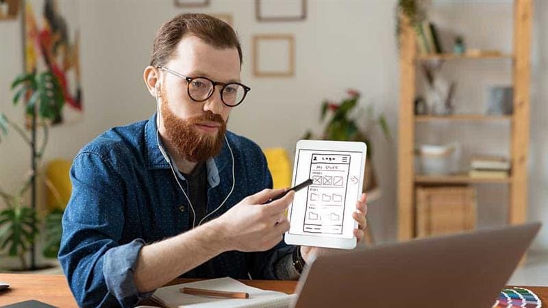 Designer planning mobile app UI at a software development company in Miami
