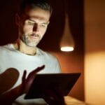 Man scrolling on tablet