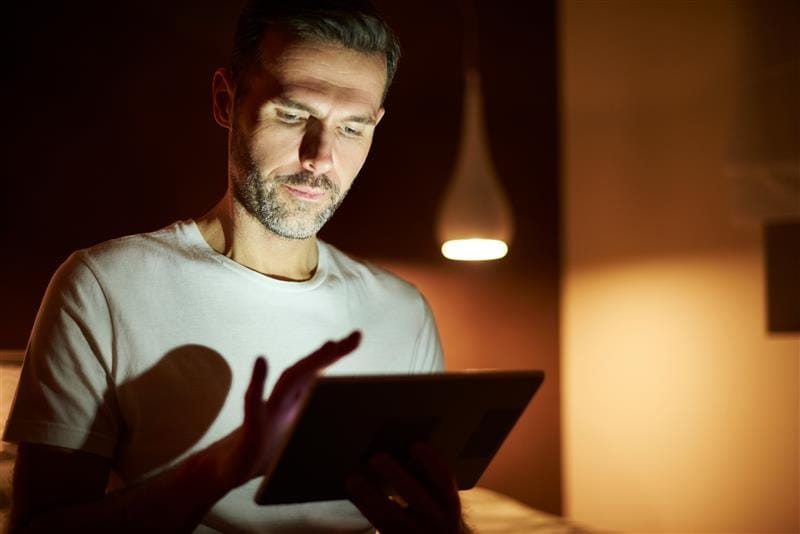 Man scrolling on tablet